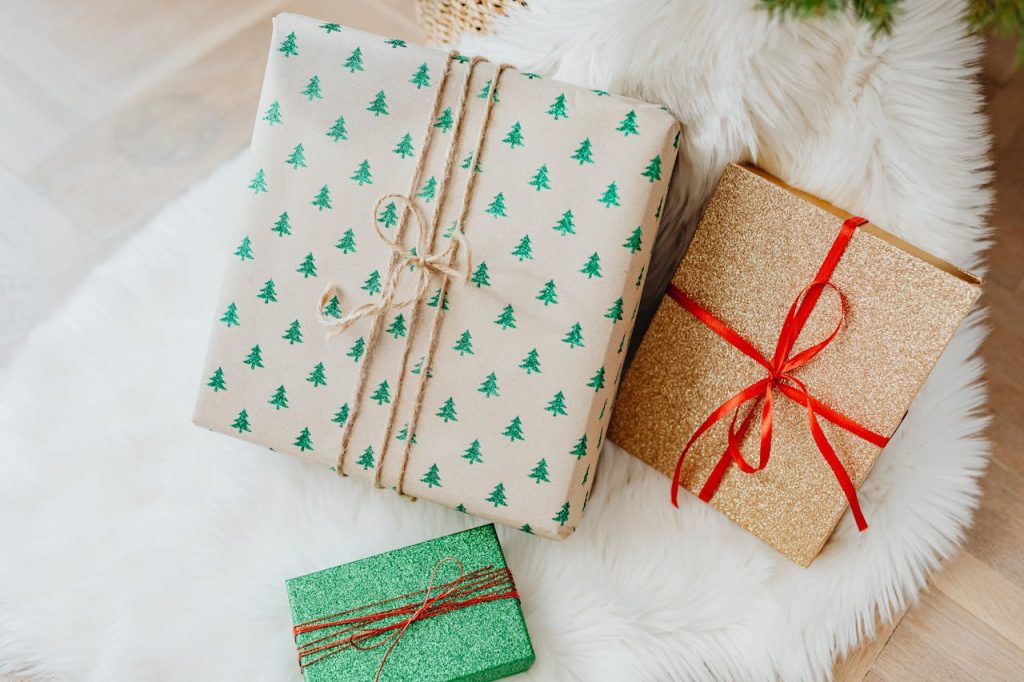 Three festive gift boxes with Christmas-themed wrapping paper, perfect for holiday celebrations.